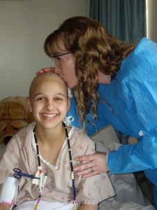Nurse Cyndi kisses my bald head before my very last hospital chemo.